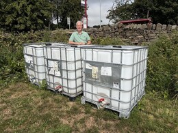 michael flesher with 1000 litre water containers